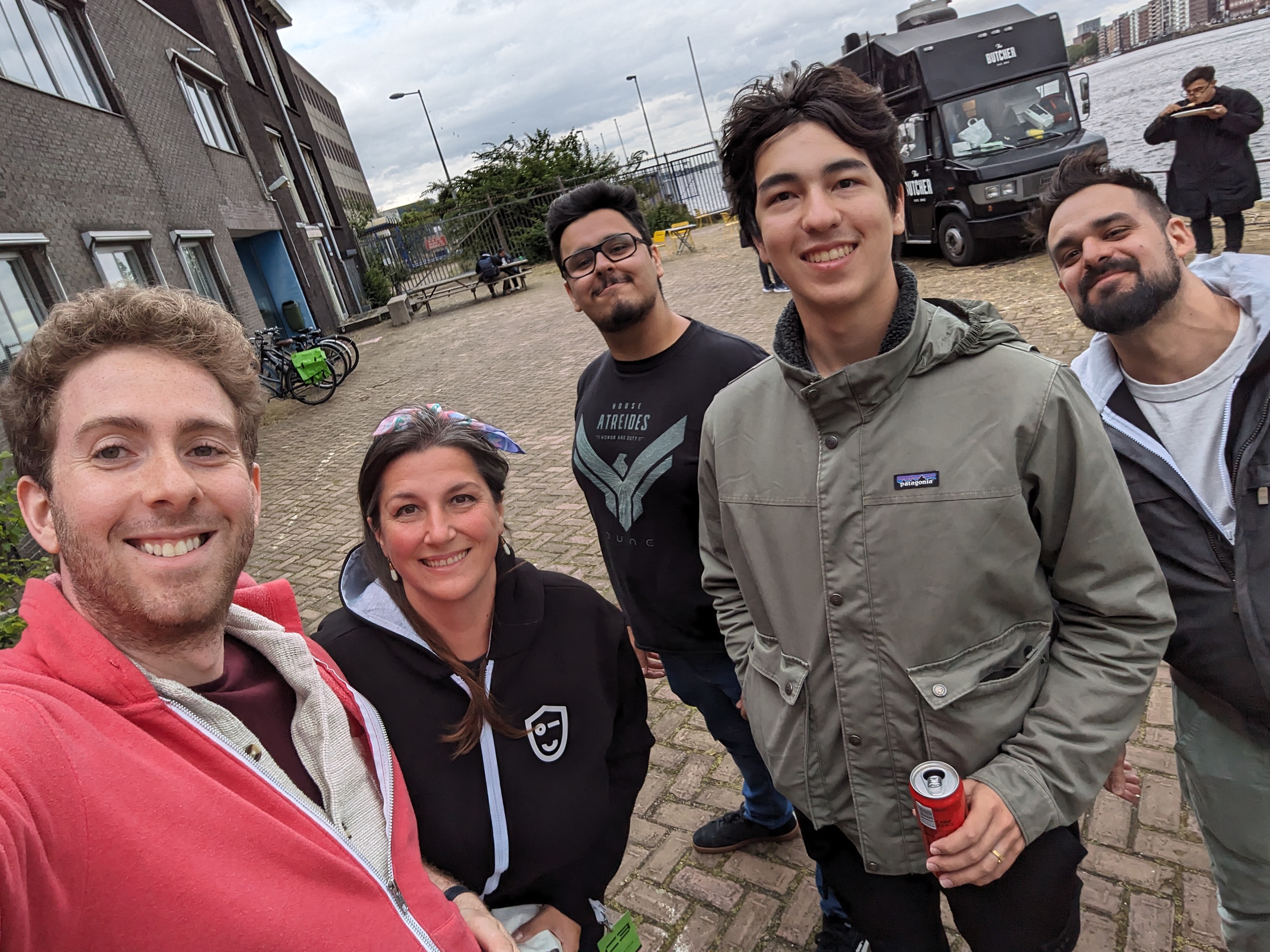 Smiling selfie of a group of people in front of a food truck.